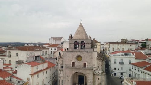 Aerial view of an old town square moving up into the sky
