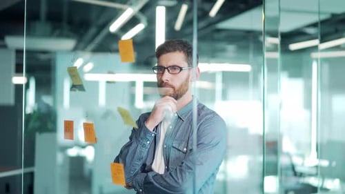 creative young entrepreneur business man in modern office uses post Papers sticky notes to share