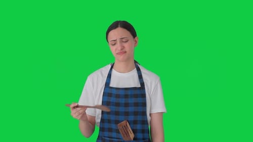 Sad Indian housewife tasting bad food Green screen