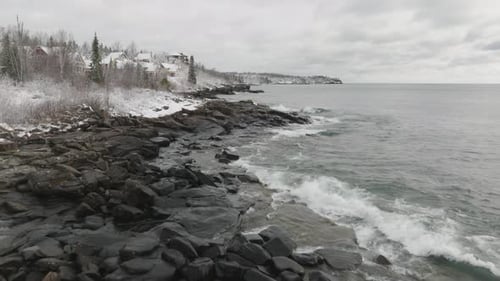Waves Crashing Ashore On Lake Superior In Winter In Minnesota, USA. - aerial shot