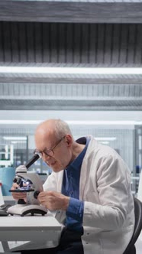 Senior Scientist Using Microscope in Modern Laboratory