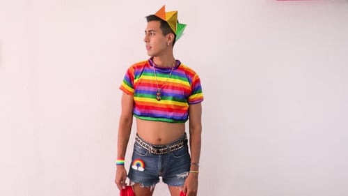 Gay effeminate guy putting the gay flag on his back. Slow motion