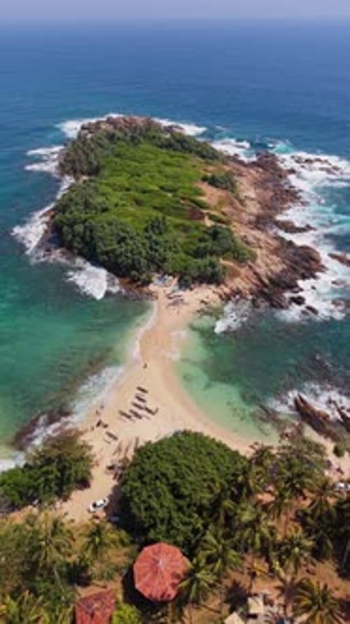 Vertical drone shot over blue beach Sri Lanka