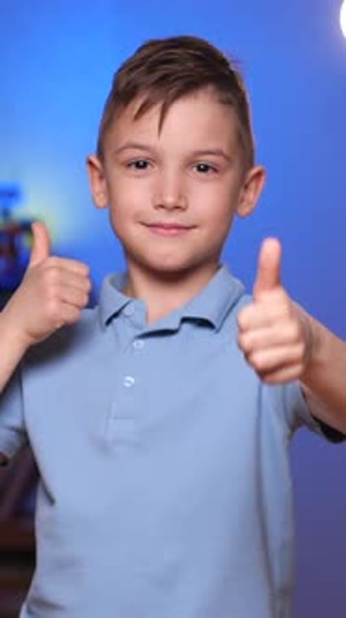 Smiling Child Gives Double Thumbs Up