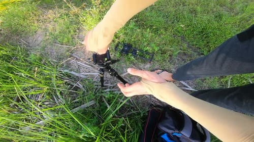 Assembling Camera Slider Outdoors on Grass