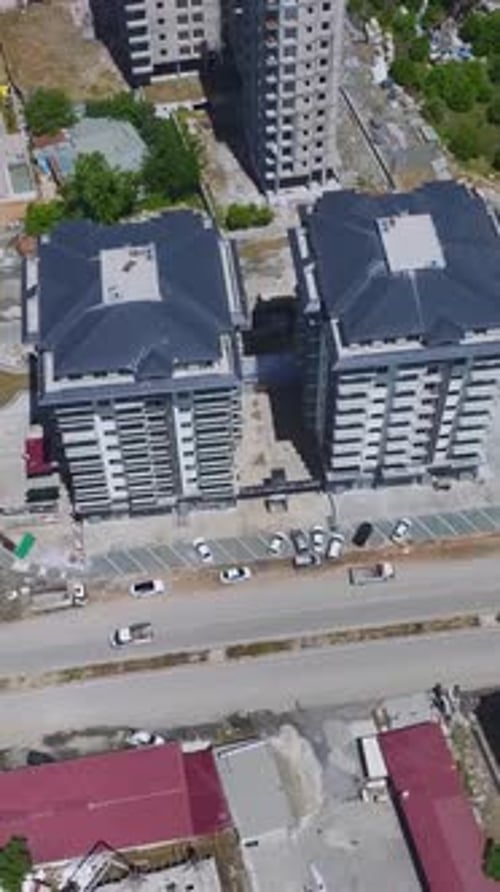 Vídeo vertical: trabajadores de la construcción en un nuevo distrito manipulan hormigón, vertidos, marcos y