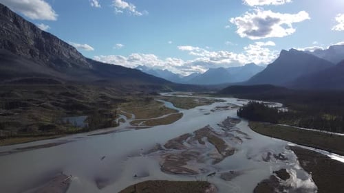Aerial view of winding river through the vast and rugged mountains of Canada