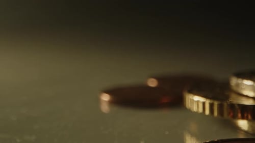 pan of a stack of Euro coins in a studio setting