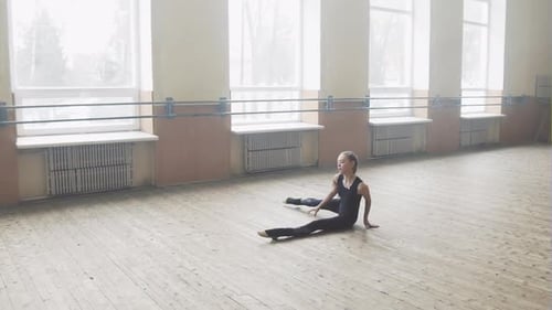 Teen Girl Performing Elegant Stretches in Dance Studio