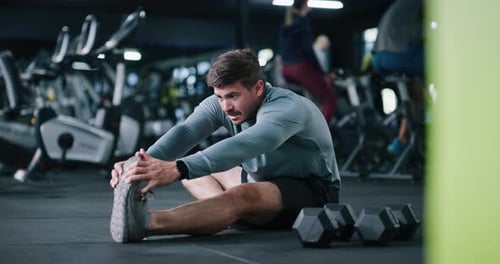 Man, fitness and stretching with preparation in gym for workout, exercise or indoor training