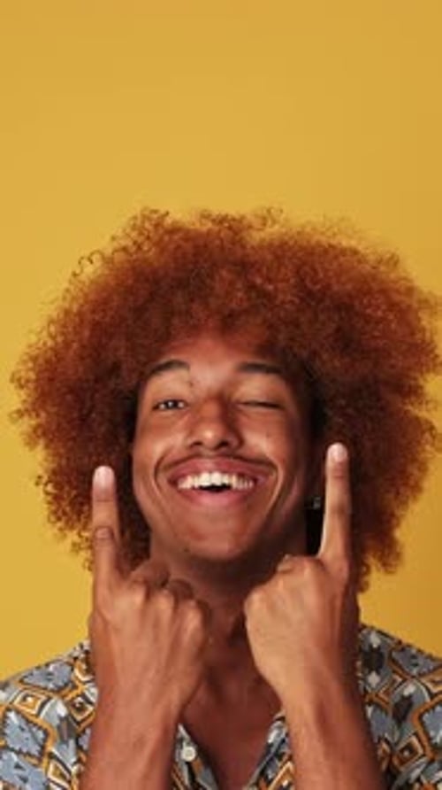 Smiling Young Adult Poses on Yellow Background
