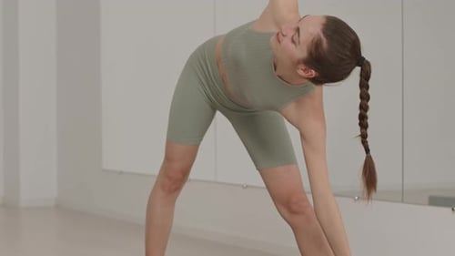 Yoga Teacher Demonstrating Extended Triangle Pose during Class