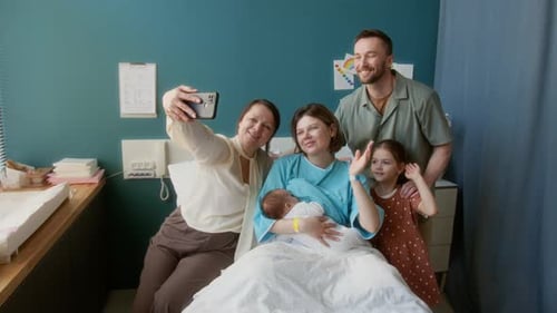 Family Posing For Selfie in Maternity Hospital