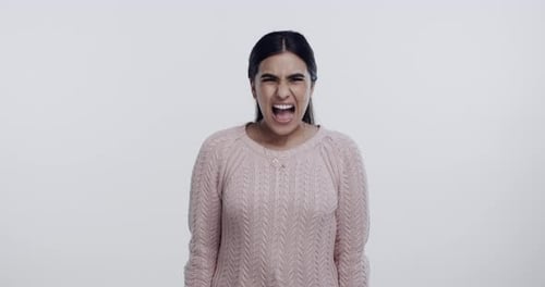 Angry, woman and scream face with mental health, stress and anxiety from problem in studio