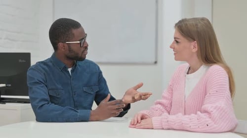 Colleagues Discussing Ideas at Workplace Meeting