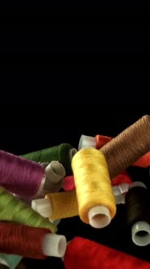 Multicolored Threads Fly on a Black Background Filmed on a Highspeed Camera at 1000 Fps