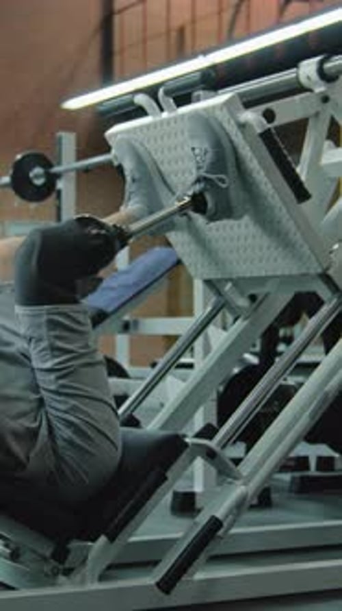 Man with Prosthetic Leg Using Leg Press Machine