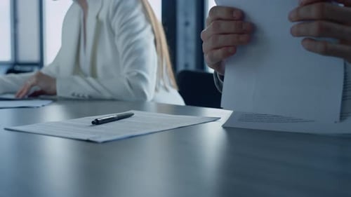 Bank manager analyzing financial contract with client in modern office