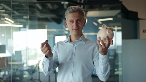 Businessman Saving Money in a Piggy Bank