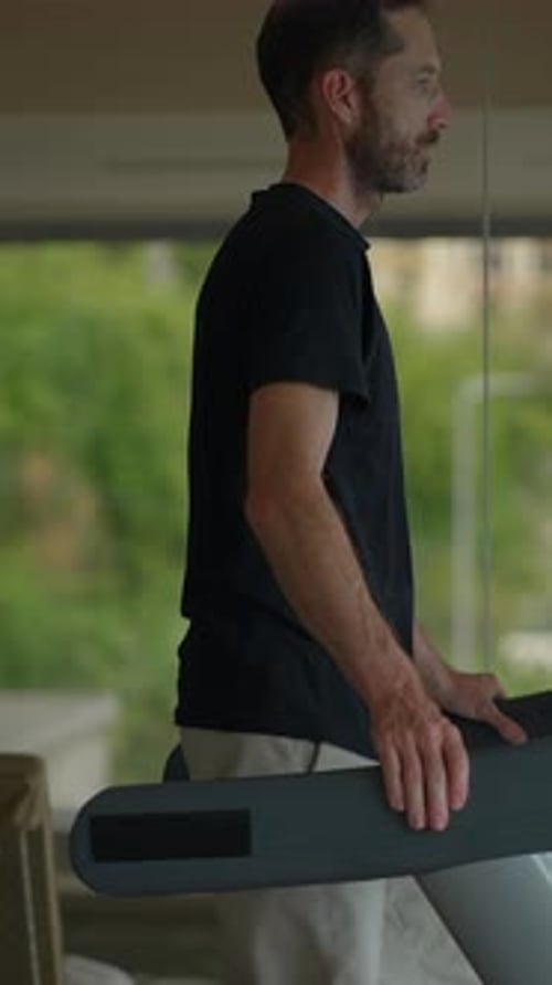 A Man is Actively Exercising on a Treadmill in a Contemporary and Modern Gym Environment