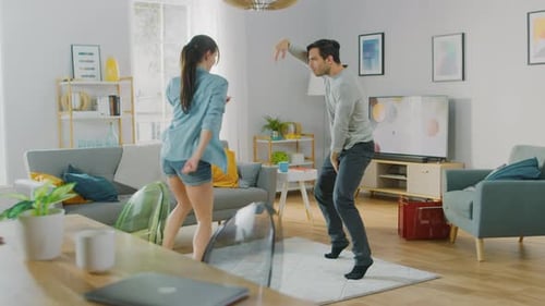 Joyful Couple Dancing Together in Living Room