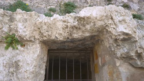 A castle jail view with the bars and lock.