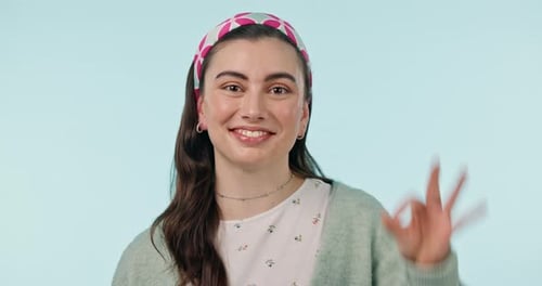 Okay hands, face and woman in studio for vote, certified review or feedback on blue background