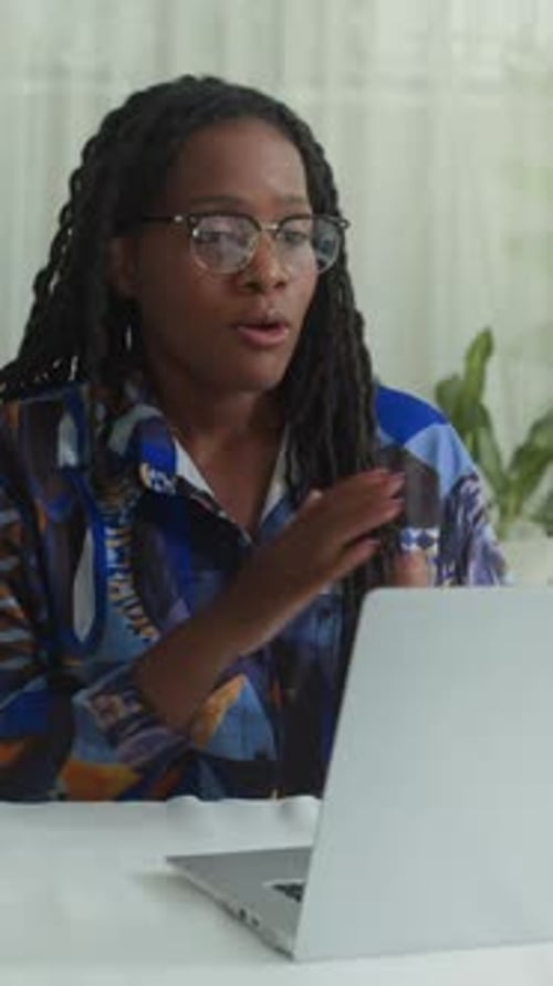 Woman Talking on Laptop Video Call at Home