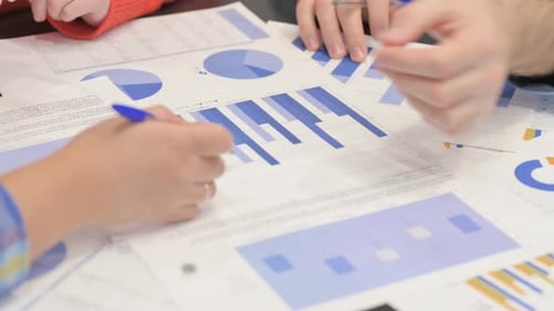 Colleagues Reviewing Financial Data in Bright Workplace