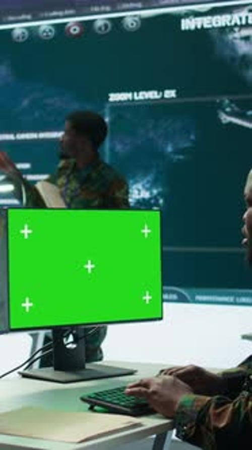 Vertical Video Soldier Analyzing Real Time Data Next to Green Screen in High Tech Office