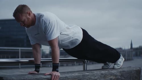 Adult Man Doing Pushups in an Urban Setting