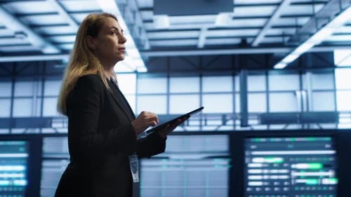 Woman in Data Center Making Sure Rigs are Functioning Optimally