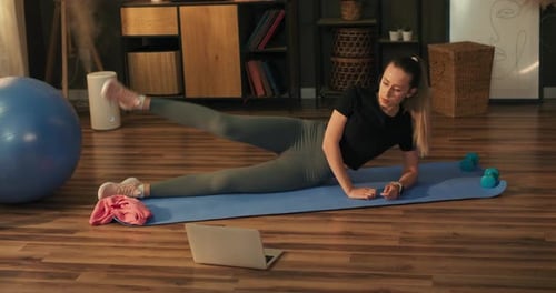Woman Doing Leg Lifts During Home Workout