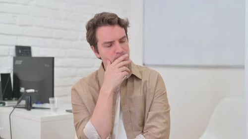 Portrait of Thinking Young Creative Man Brainstorming