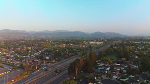 Roads full of cars in Napa, California, USA. Hot air balloons in the air over the city.