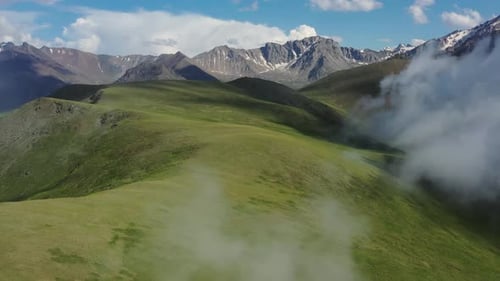 Aerial View of Verdant Mountains and Cloudy Skies