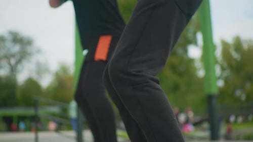 Urban Park Setting Featuring Energetic Squat Exercise with Friends Closeup of Athlete Doing Precise
