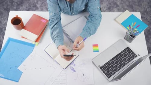 Working at desk with computer and papers