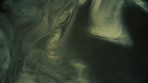 Mysterious swirling smoke patterns evolve in dark, dramatic motion