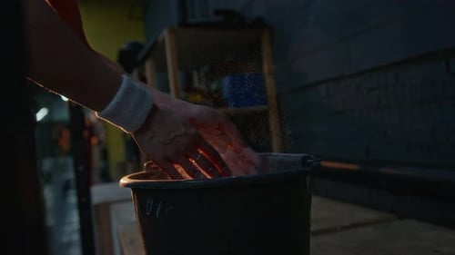 Person Prepares for Workout with Powder and Bucket