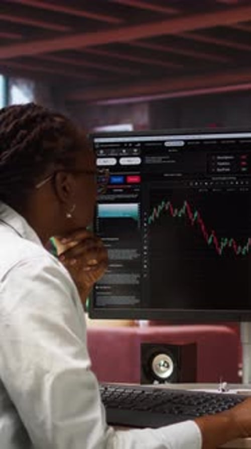 Financial Analyst Reviews Candlestick Chart in Office