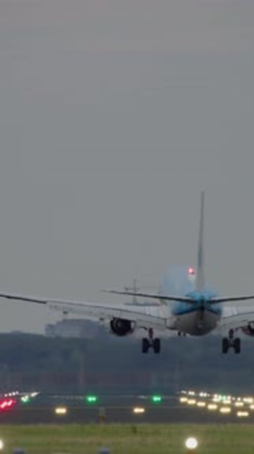 Airplane Gracefully Landing on a Busy Airport Runway