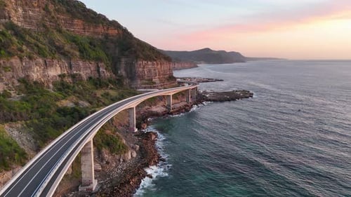 Breathtaking aerial drone shot of the Sea Cliff Bridge, showcasing its sweeping curves along the dra