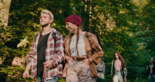 Smiling Woman Talking With Friend While Exploring Woods
