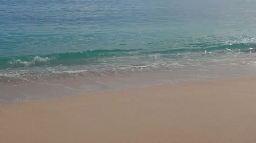 Title Slow Motion Tropical Beach Wave Crushing on Clean Sand