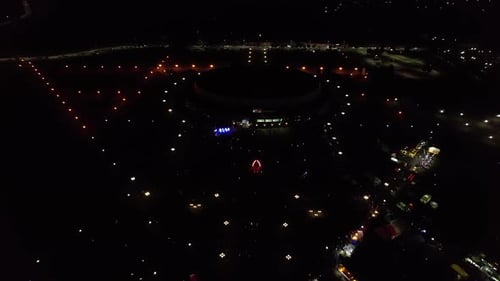 Stunning Aerial View of Nightlife of City During Holiday with Trade and Concert in Square Near Round