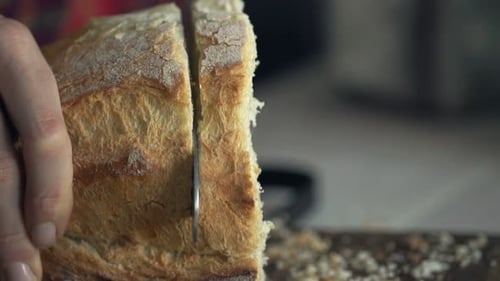 Slicing Freshly Baked Bread on Cutting Board