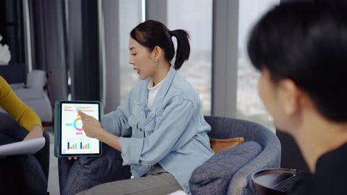 Adults Meeting in Bright Modern Office With Tablet