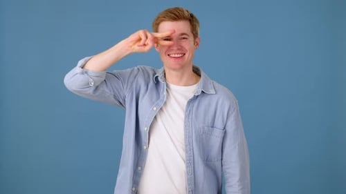 Carefree Handsome Man Dancing Cheerful on Blue Background