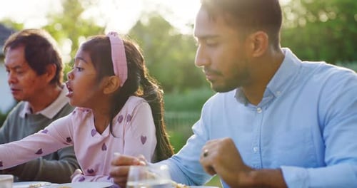 Three Family Members Eating Lunch Outside Together